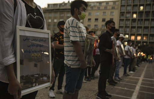 Protesters in Athens attend a memorial for victims of an attack targeting the Hazara community in Kabul.